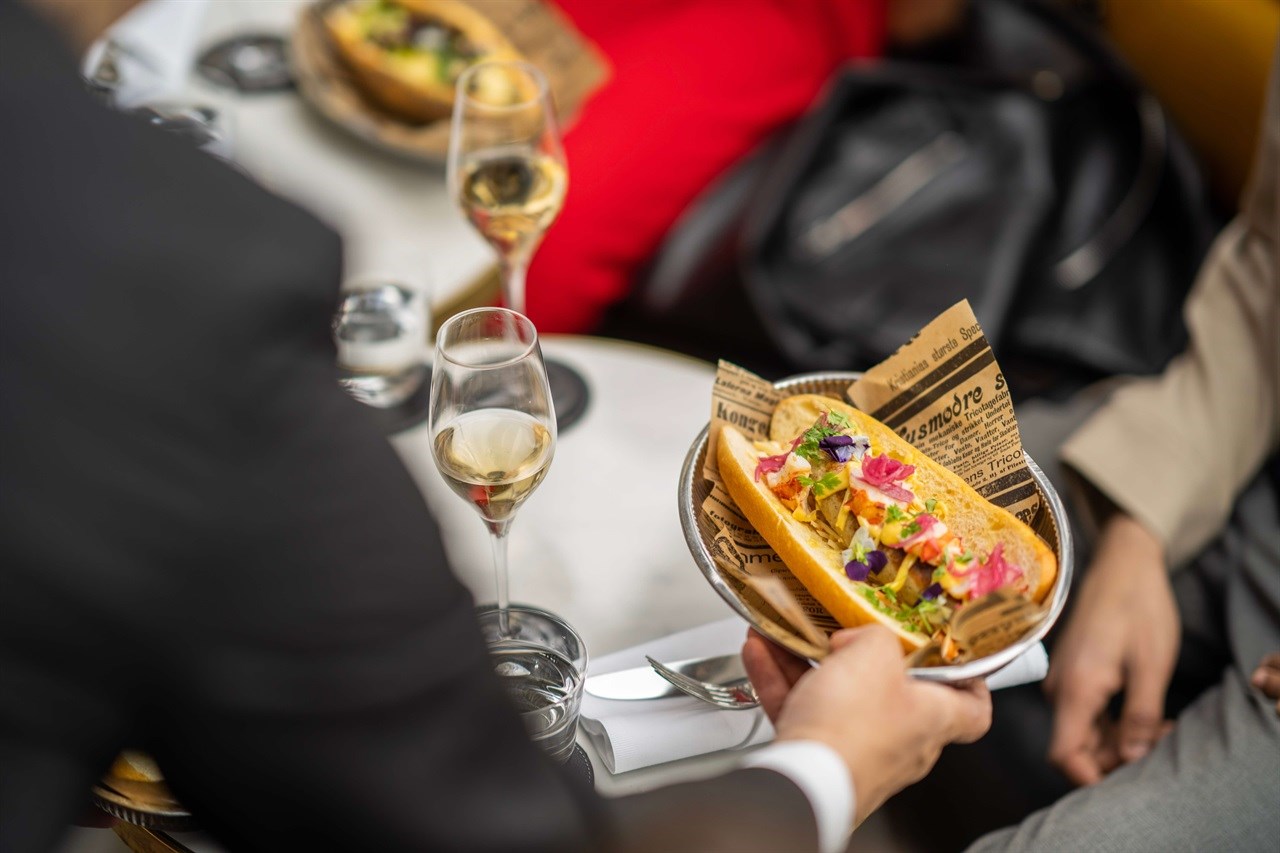 Champagne and gourmet hot dogs are served on the rooftop of Grand Hotel Oslo.